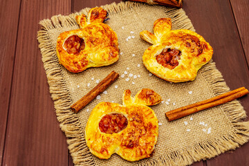 Homemade apple dessert, portioned puffs with fragrant cinnamon sticks