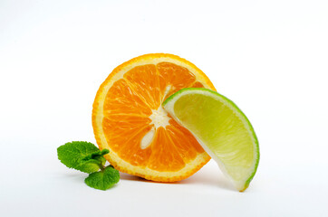 Fototapeta na wymiar Closeup of slice of lime and cutted orange, green fresh mint on the white background