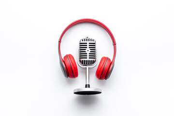 Podcast and streaming record. Microphone and headphones on table, top view