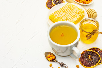 Healing sea-buckthorn tea with honeycombs and lemon