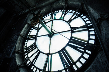 Interior of old big tower with close-up on clock face mechanism inside brick space