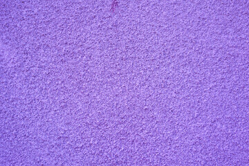 A close up of a violet wall. old textured background with abstract stucco.