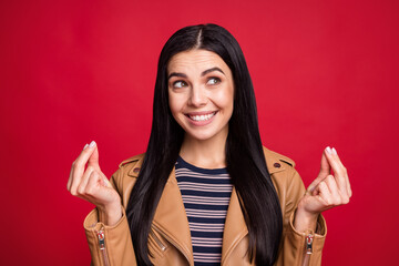 Portrait of charming lady hands fingers show money sign look interested empty space isolated on red...