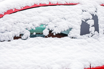snow-covered car window, natural background, first snow