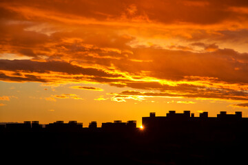 Fototapeta na wymiar Sunset over city buildings