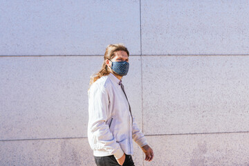 man walking down the street with mask
