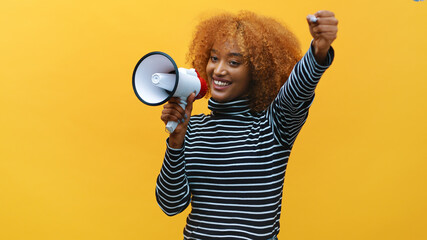 African american black woman with curly hair shouting into the megaphone. High quality photo