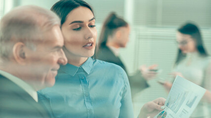 young colleagues are talking standing in the office