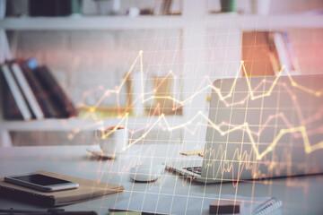 Financial graph colorful drawing and table with computer on background. Double exposure. Concept of...