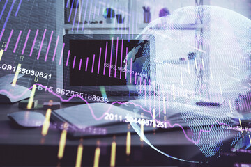 Financial graph colorful drawing and table with computer on background. Multi exposure. Concept of international markets.