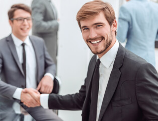 happy entrepreneur shaking hands with his business partner