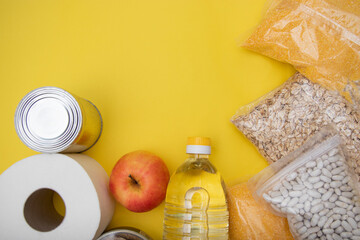 Donations food with canned food on yellow background canned goods and dry food non perishable with cooking oil, donate concept