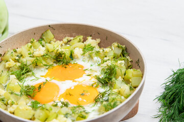 scrambled eggs and potatoes in a frying pan. Selective focus. Top view.
