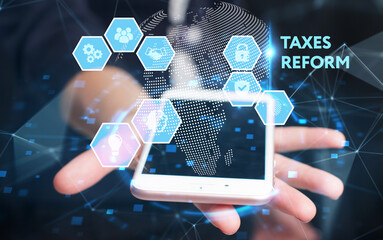 Business, Technology, Internet and network concept. Young businessman working on a virtual screen of the future and sees the inscription: Taxes reform