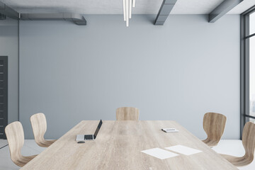 Minimalistic conference interior with large wooden  meeting table and chair.