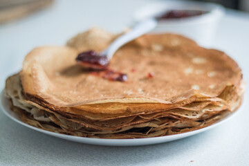 pancakes on a plate with jam, background, breakfast
