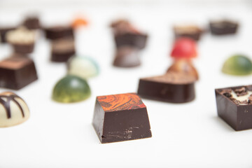 lot of variety chocolate pralines, top view of various chocolate pralines isolated on white background