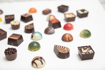 lot of variety chocolate pralines, top view of various chocolate pralines isolated on white background