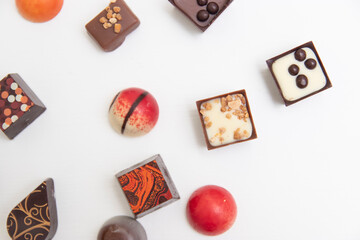 lot of variety chocolate pralines, top view of various chocolate pralines isolated on white background