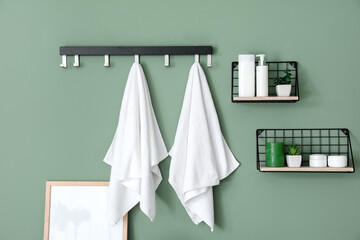 Modern interior of stylish bathroom with towels on hooks