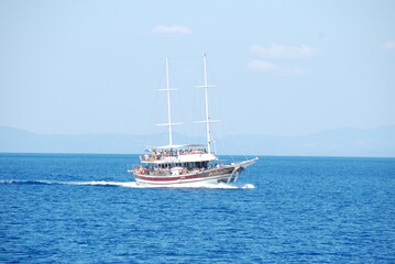 Fototapeta premium a small boat transports tourists
