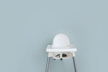 Baby highchair on color background