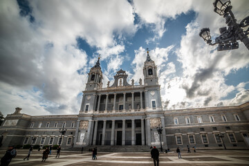Obraz premium People by Almudena cathedral on a cloudy day