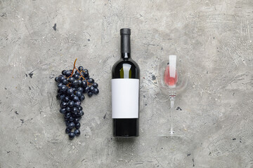 Tasty red wine with fresh grapes on grunge background