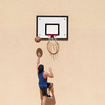 Low Angle View Of Man Playing Basketball