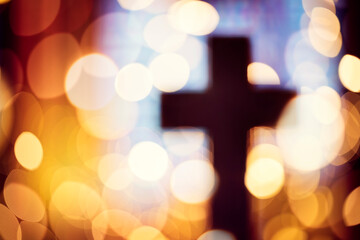 Abstract cross silhouette in church interior against stained glass window concept for religion and ...