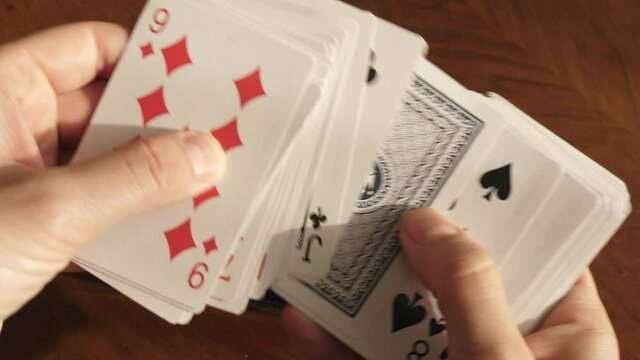 shuffling playing cards, playing cards in hands