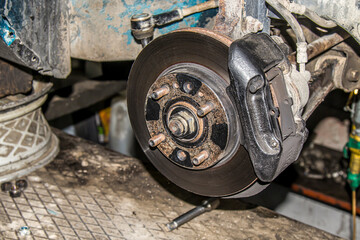 Fototapeta premium Car wheel with removed pneumatic tire and rim of the disk, visible connecting elements of the disk, hub and pneumatic tires, disassembly and repair of the car wheel