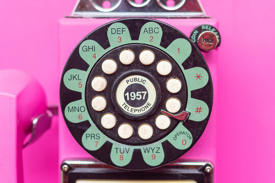 pink coin public telephone dial