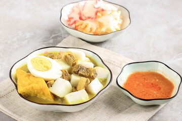 Lontong Kari Sapi or Indonesian Beef Curry with Rice Cake. Street Food Popular for Breakfast in West Java, Indonesia