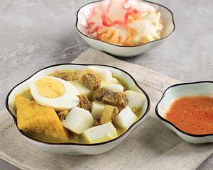 Lontong Kari Sapi or Indonesian Beef Curry with Rice Cake. Street Food Popular for Breakfast in West Java, Indonesia