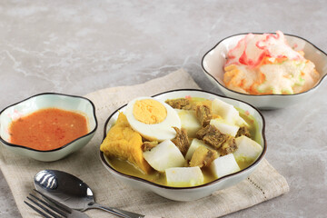 Lontong Kari Sapi or Indonesian Beef Curry with Rice Cake. Street Food Popular for Breakfast in West Java, Indonesia
