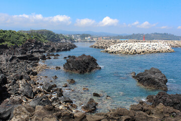 Fototapeta na wymiar Blue ocean waves with rocks on the beach