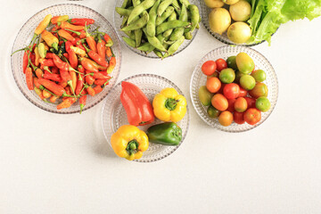 .Flatlay Composition of Fresh Vegetable on Clear Plate Above Cream Table. Vibrance Color Pleasing Eye. Concept of Dieting .