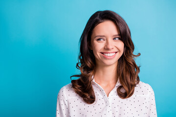 Fototapeta premium Portrait of optimistic brunette girl look empty space wear shirt isolated on teal color background
