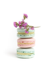 Three tasty colorful macarons on the white background.