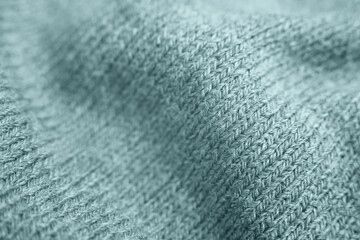 Close up of green knitted textured background.