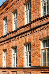 Naklejka premium Beautiful vintage red brick building at sunny day