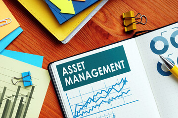Asset Management papers with charts and graphs.