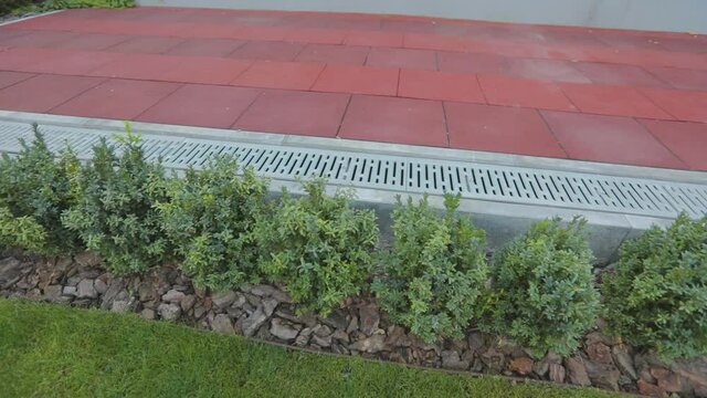 Close-up of paving slabs with a drainage system. Cobblestone close-up. Drainage system