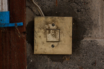 old dirty white light switch on the wall