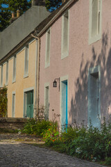 Fototapeta na wymiar Pink and Cream Cottages on a Cobbled Street in Culross Scotland