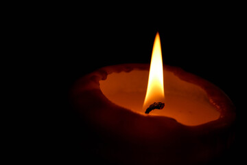 horizontal wallpaper background burning candle in the dark close up