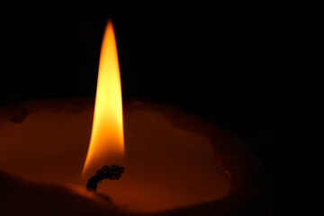 horizontal wallpaper background burning candle in the dark close up