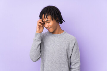 Young african american man isolated on purple background laughing