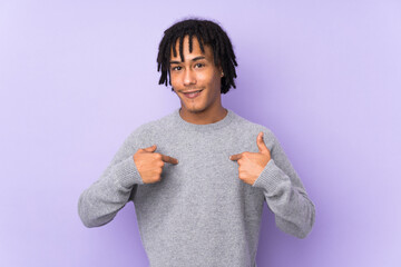 Young african american man isolated on purple background with surprise facial expression